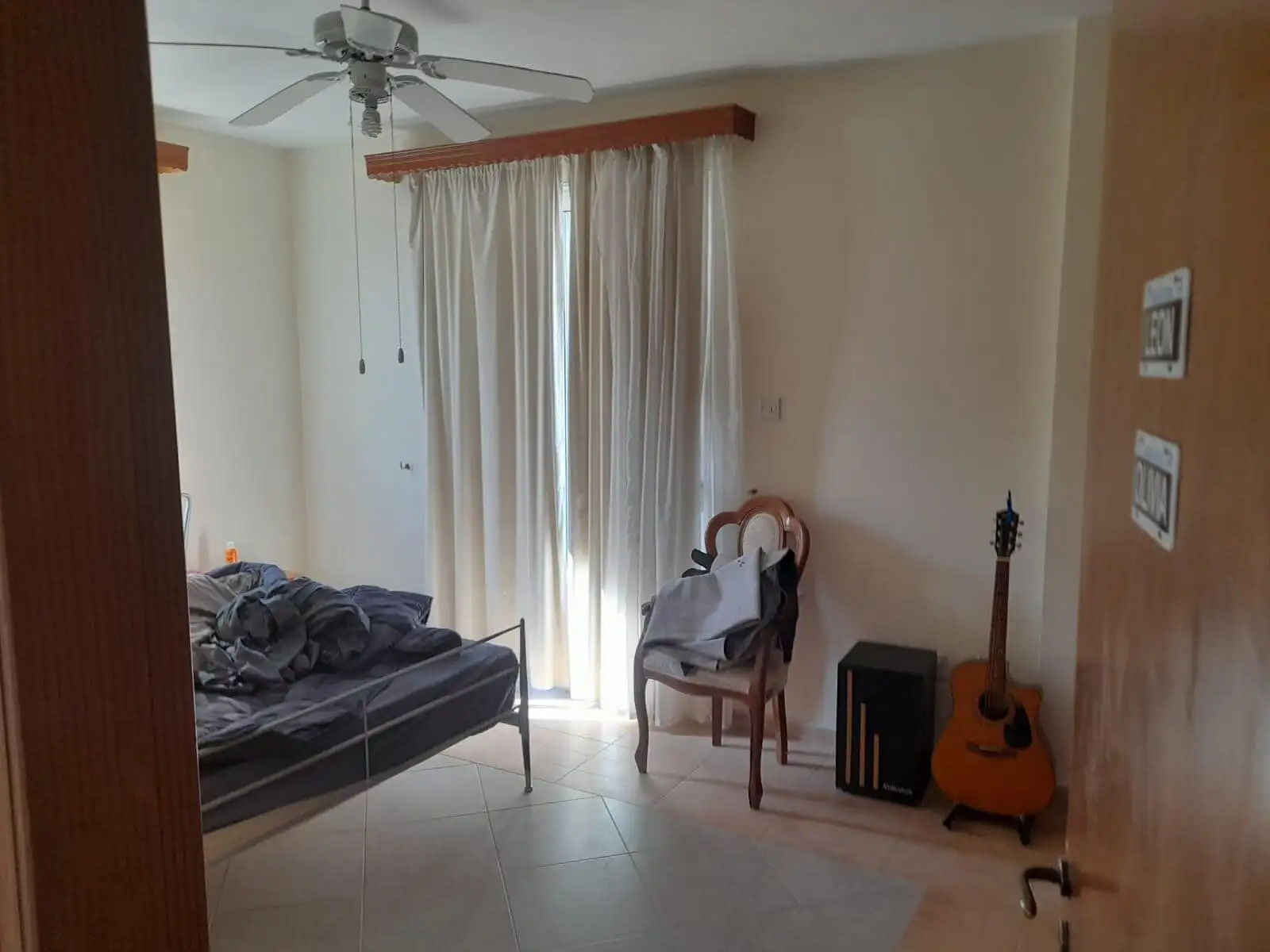Spacious living room with large window and natural light in a 4-bedroom villa in Aradippou, Larnaca.