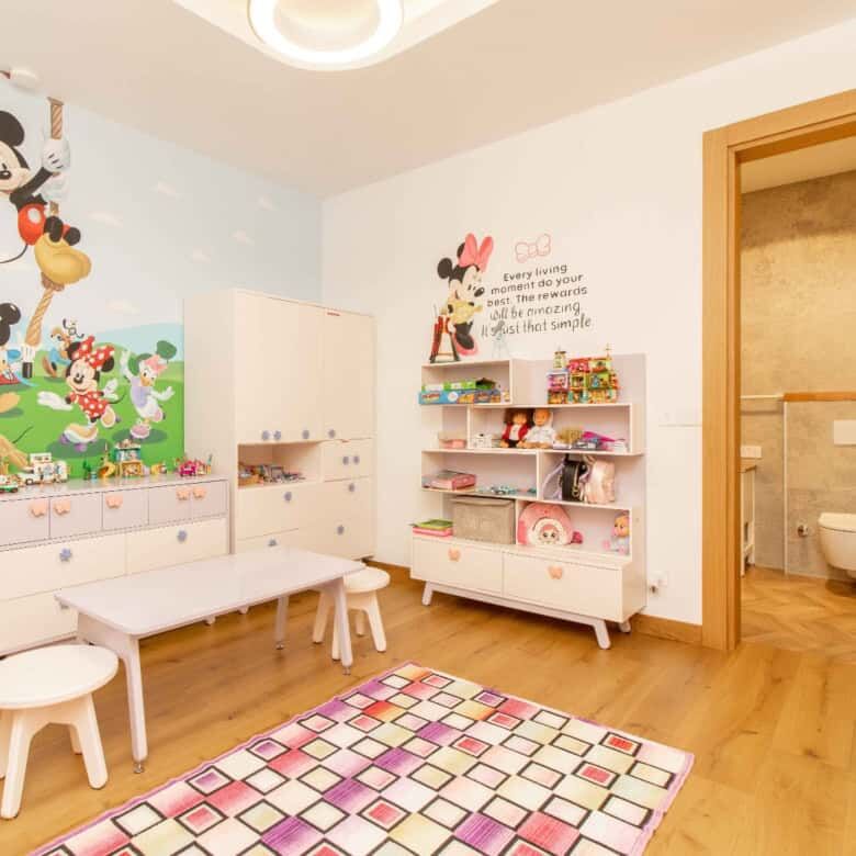 Spacious children's playroom with colorful Mickey Mouse decor and furniture in a luxury villa in Kyr.