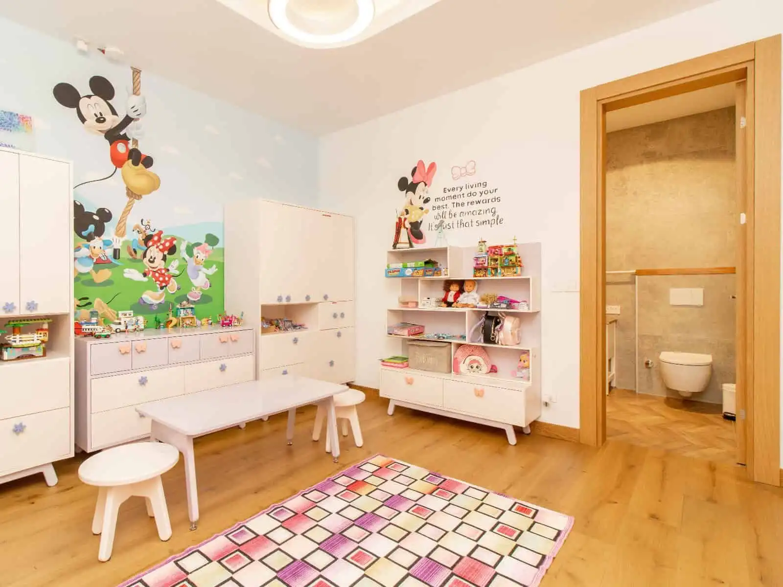 Spacious children's playroom with colorful Mickey Mouse decor and furniture in a luxury villa in Kyr.