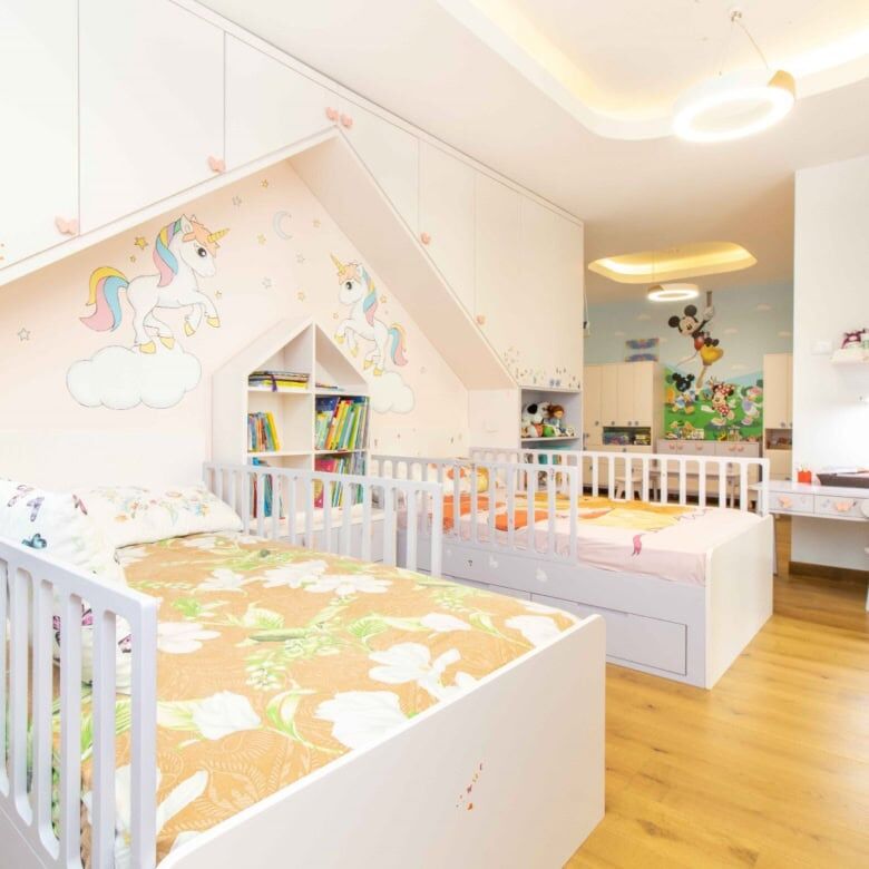 Bright children's bedroom with unicorn wall art and colorful decor.