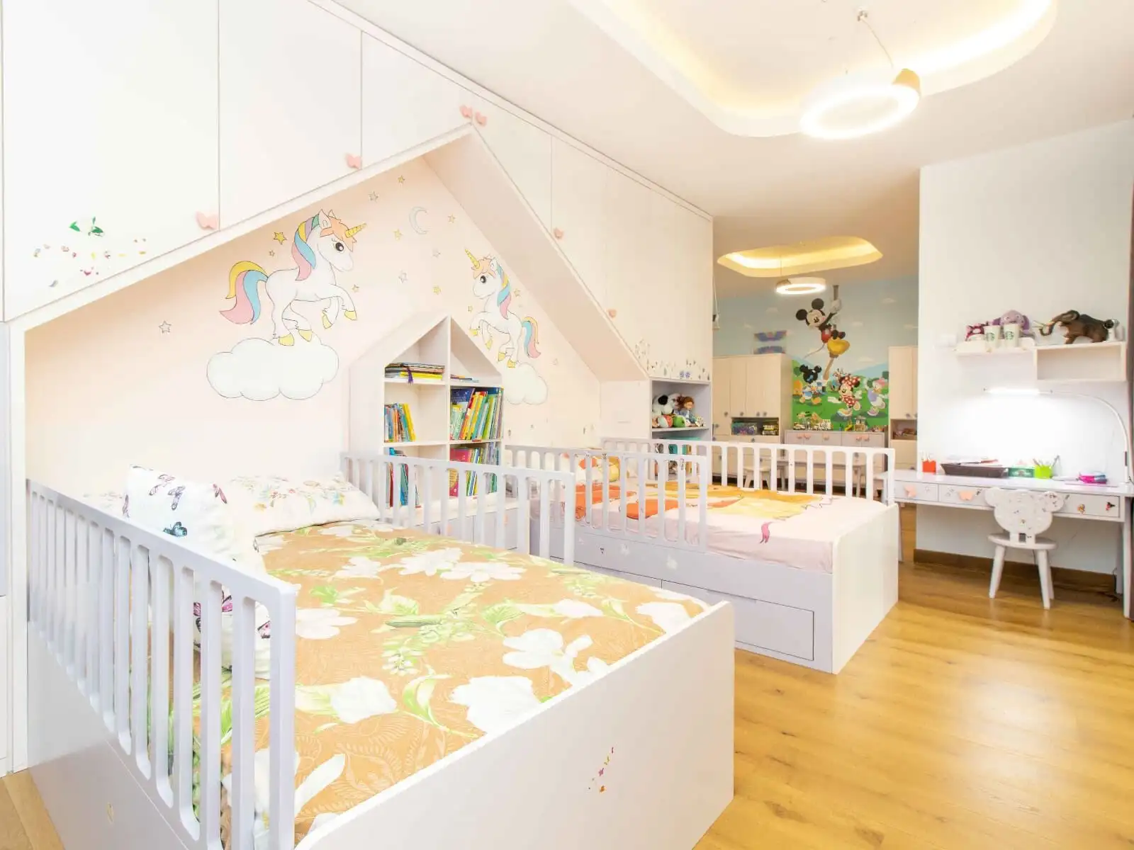 Bright children's bedroom with unicorn wall art and colorful decor.