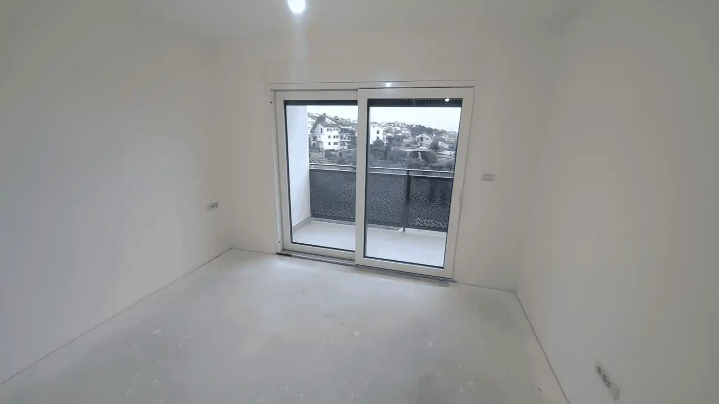 Modern duplex interior with balcony in Kvarner near Rijeka Bright empty room with large glass door leading to balcony in Kvarner duplex.