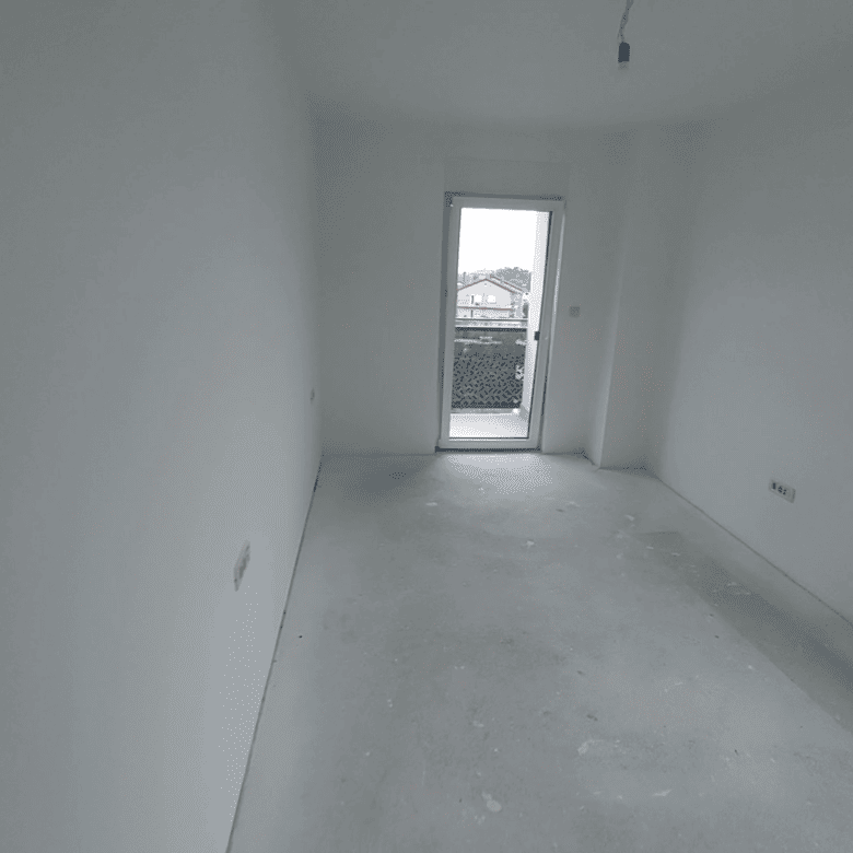 Interior of a new duplex apartment in Kvarner, Croatia, with large windows and bright space.
