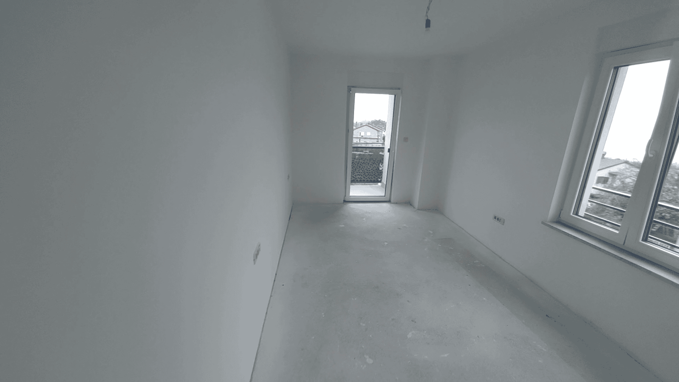 Interior of a new duplex apartment in Kvarner, Croatia, with large windows and bright space.
