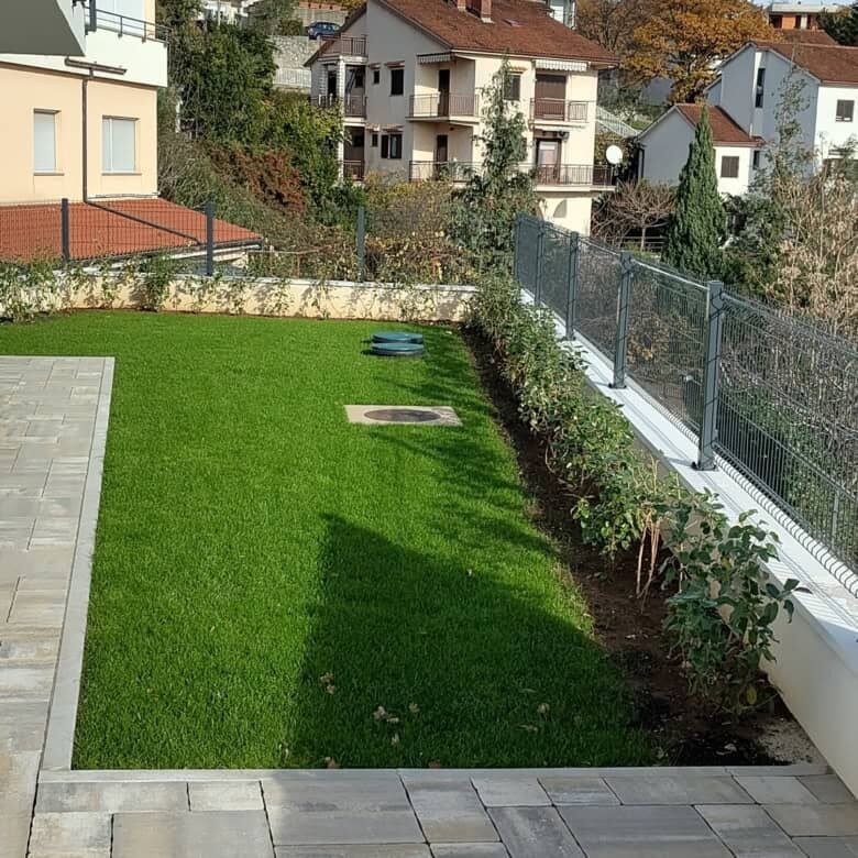 Duplex in Kvarner near Rijeka featuring a lush garden and panoramic landscape views. Perfect for com.