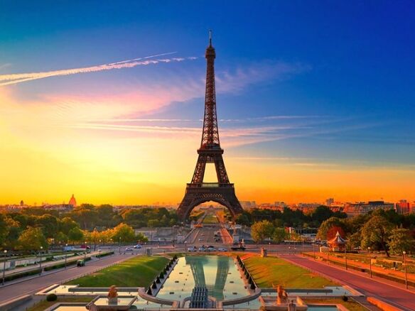 Eiffel Tower illuminated at sunset in Paris, France.
