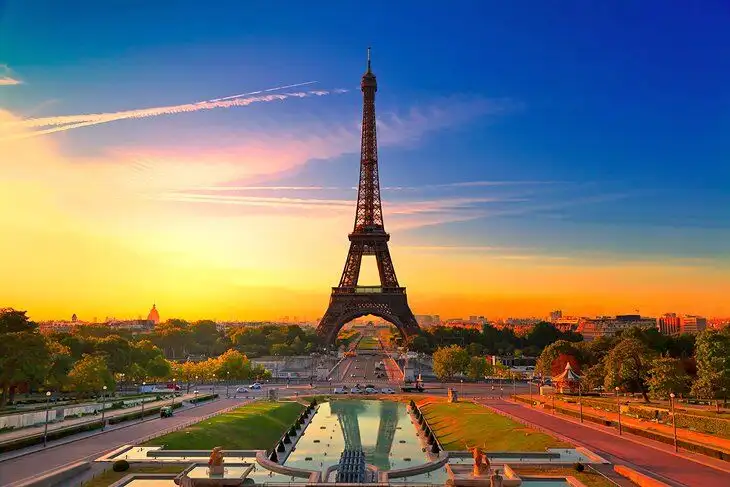 Eiffel Tower illuminated at sunset in Paris, France.