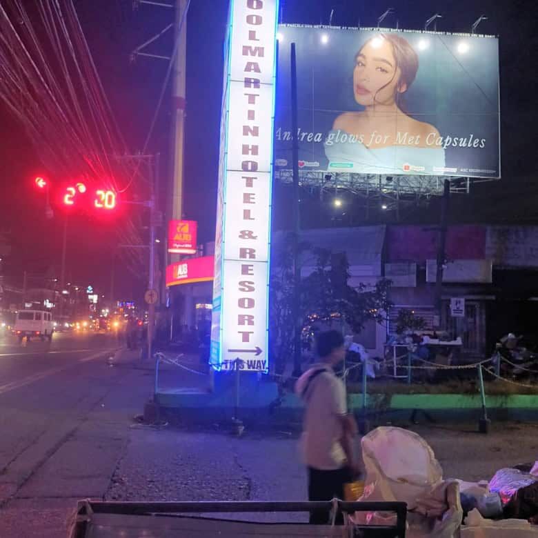 Resort hotel signboard at night in Cavite, Philippines, promoting a relaxing vacation destination.
