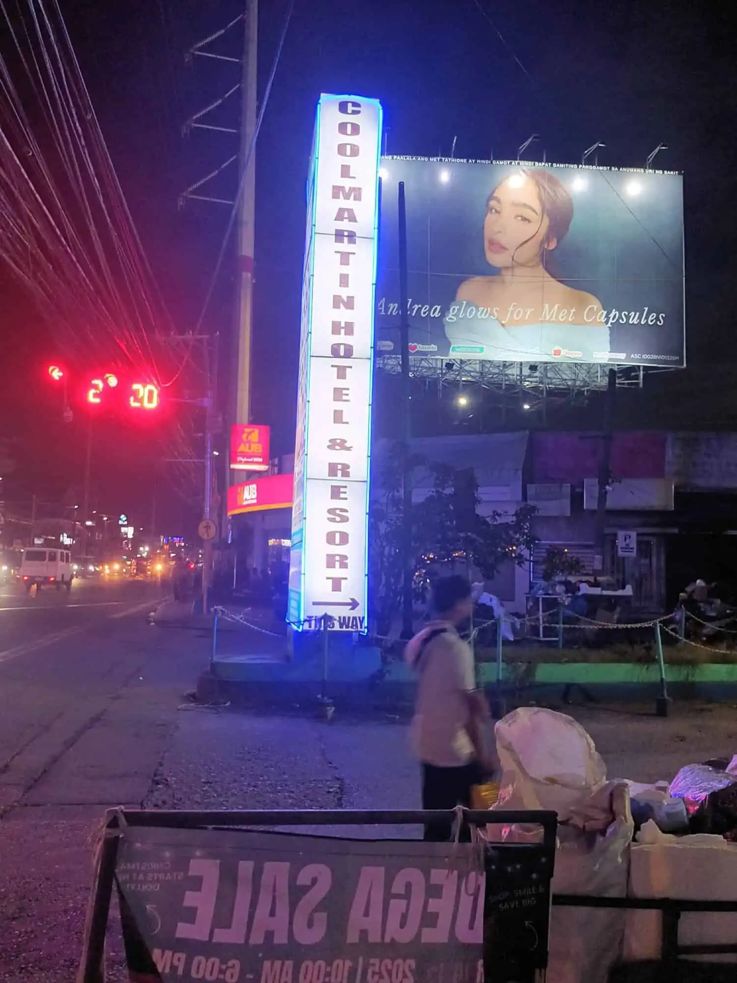 Resort hotel signboard at night in Cavite, Philippines, promoting a relaxing vacation destination.