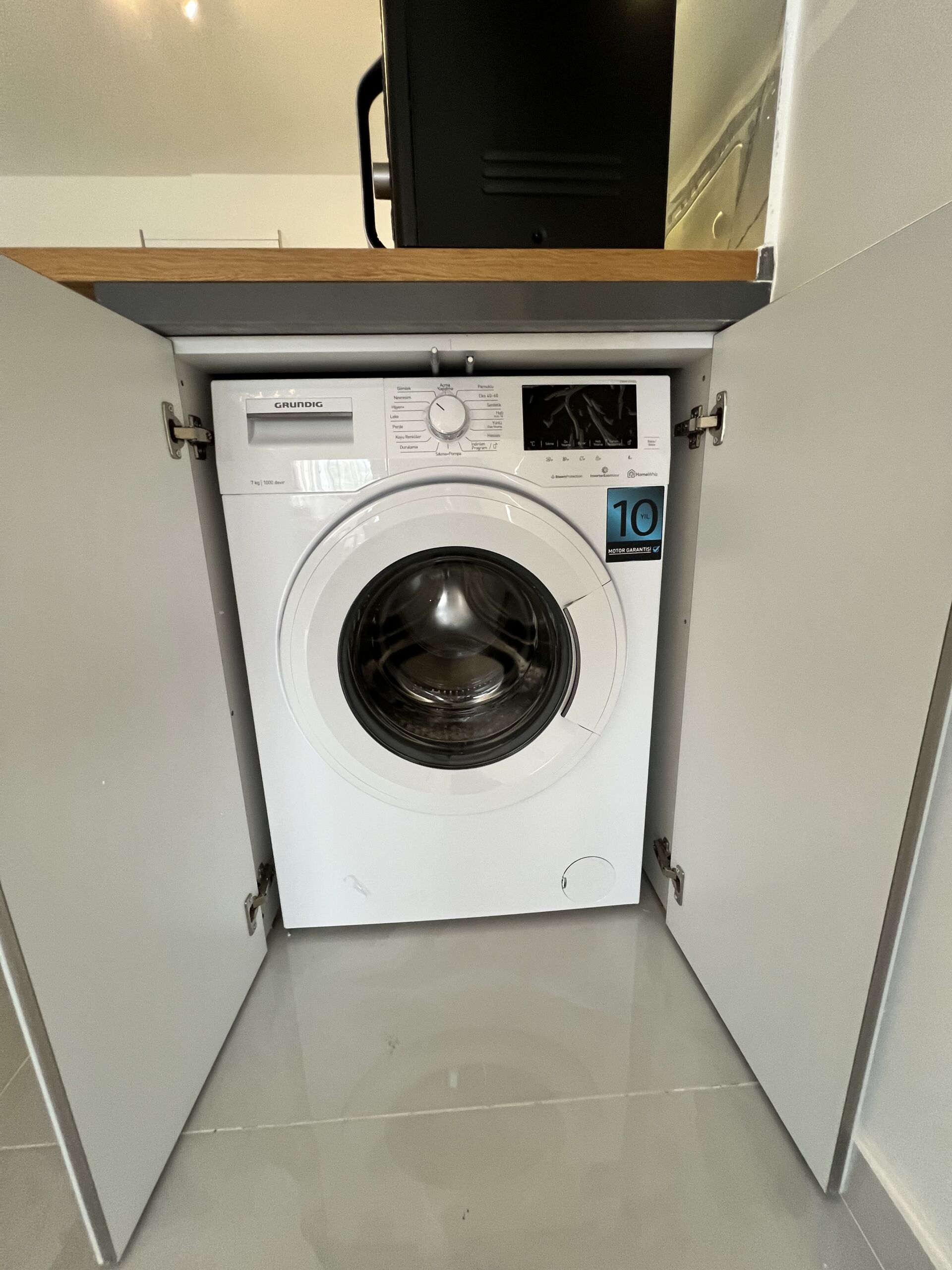 Modern 1+1 Apartment in Caesar Resort Compact washing machine in Caesar Resort apartment.