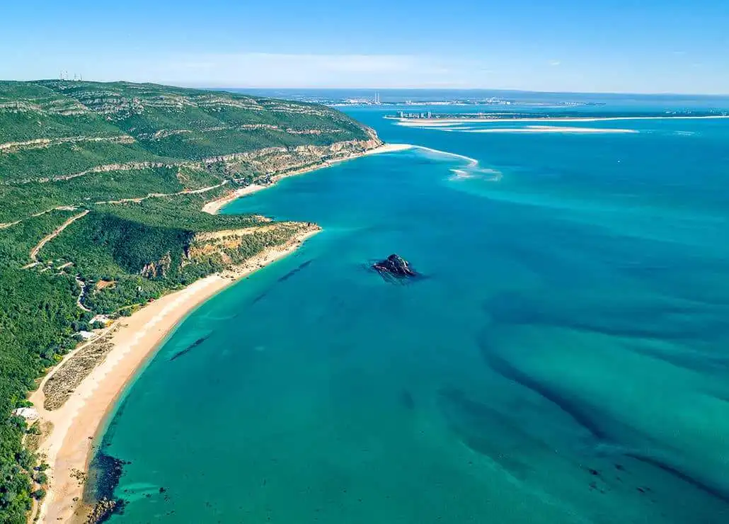 Beautiful coastal view of Setubal with sandy beaches and lush green hills.