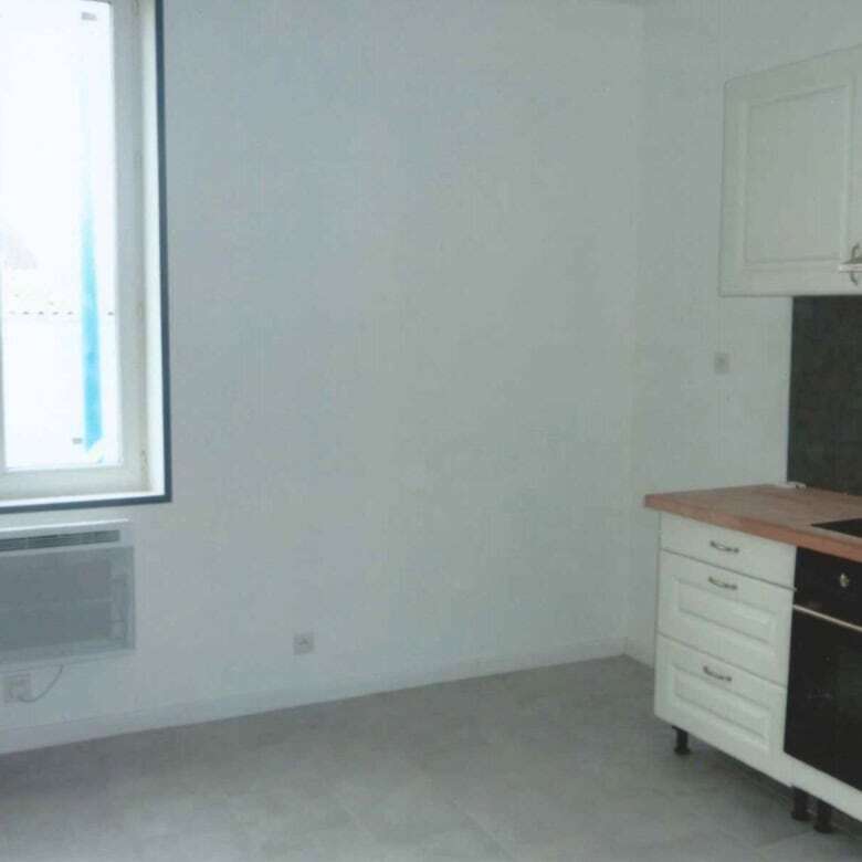 Bright kitchen with modern appliances and large window in seaside property.