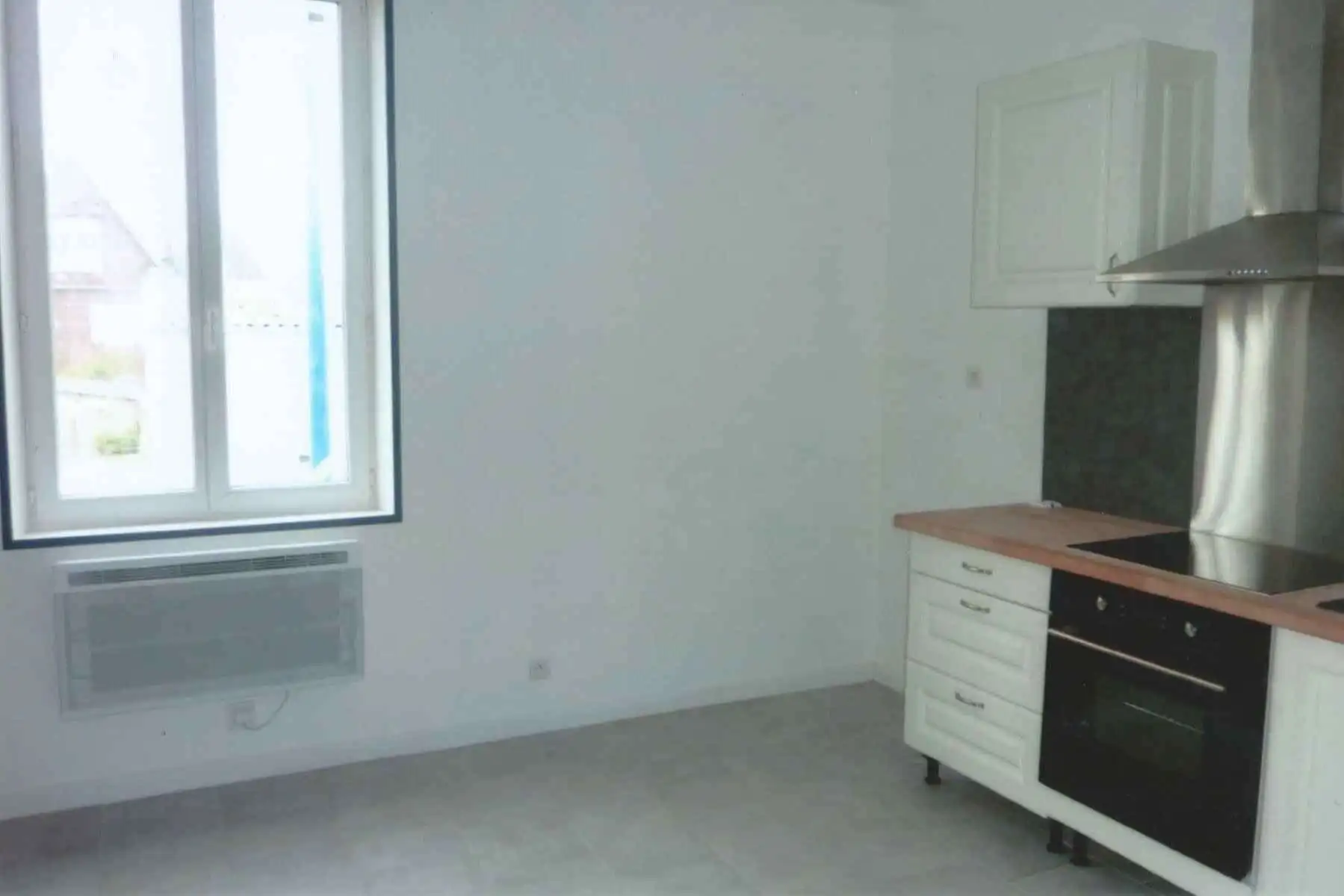 Bright kitchen with modern appliances and large window in seaside property.
