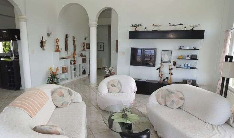 Elegant living room with white sofas and modern decor in a luxury villa.