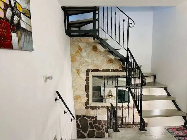 Chiaramonti Sardinia 3-bedroom house with spiral staircase and stone accents.