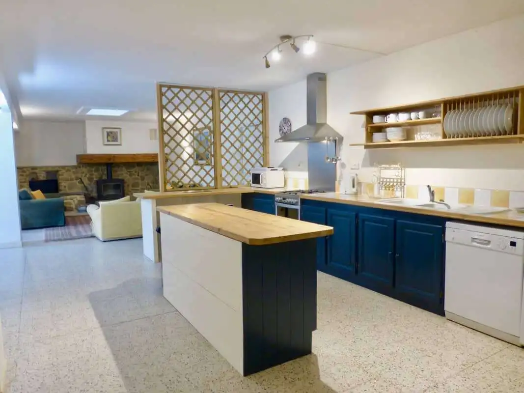Elegant country estate kitchen in Branoux les Taillades, Occitanie. Modern design with blue cabinetr.