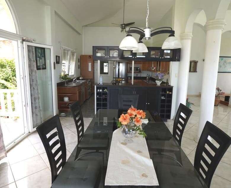 Elegant dining room with modern furnishings in a luxury villa in Prospect, St. Vincent.