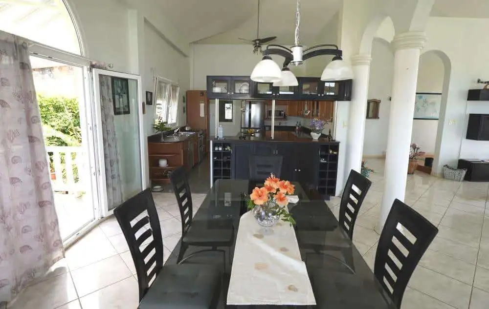 Elegant dining room with modern furnishings in a luxury villa in Prospect, St. Vincent.