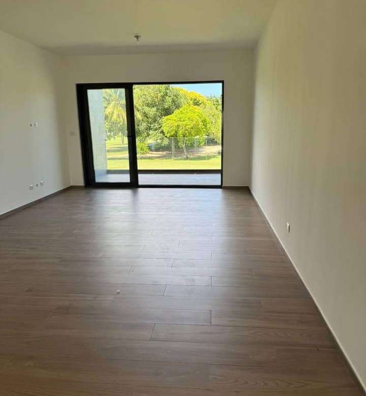 Modern living room with large glass doors and scenic outdoor views.