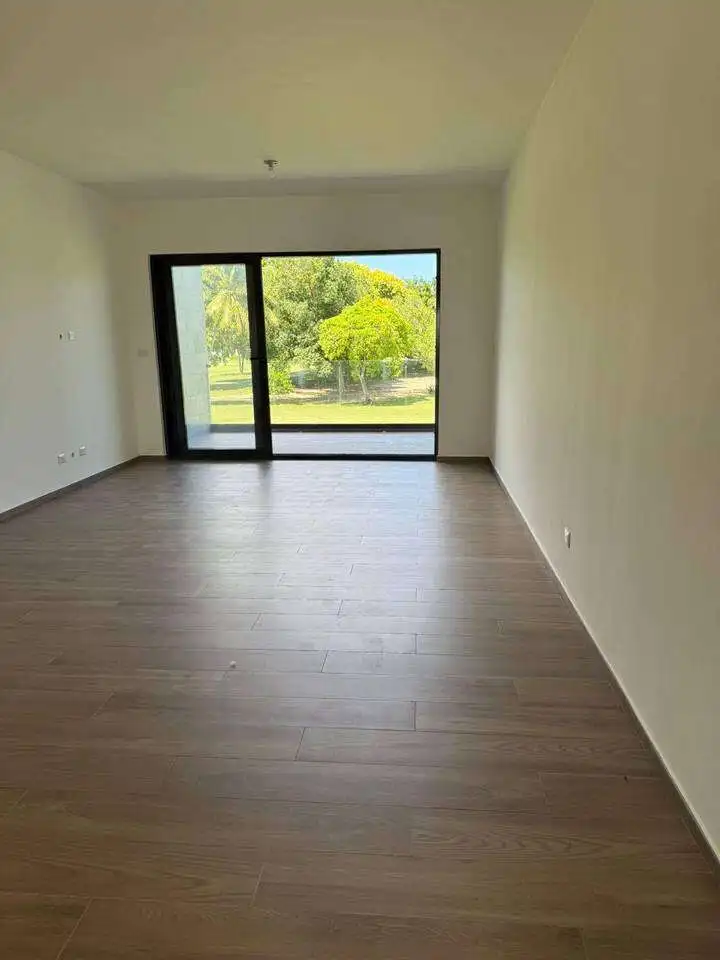 Modern living room with large glass doors and scenic outdoor views.