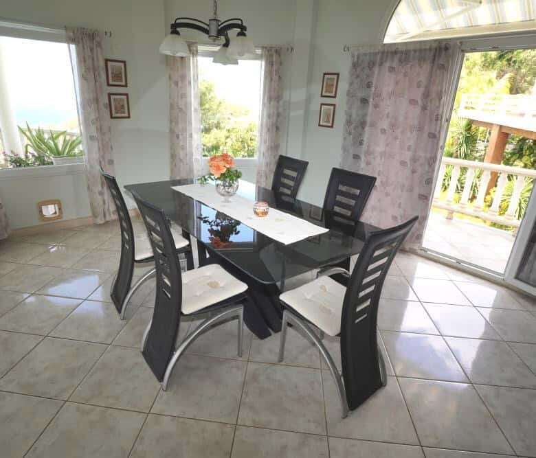 Elegant dining room with large windows and balcony view.