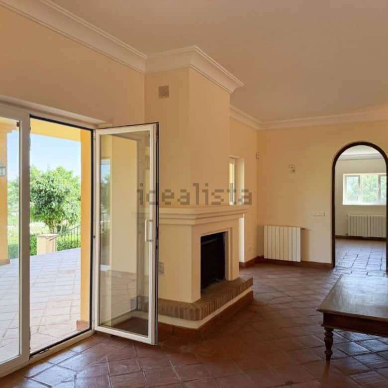 Beautiful living room with fireplace and access to outdoor terrace in Sotogrande.