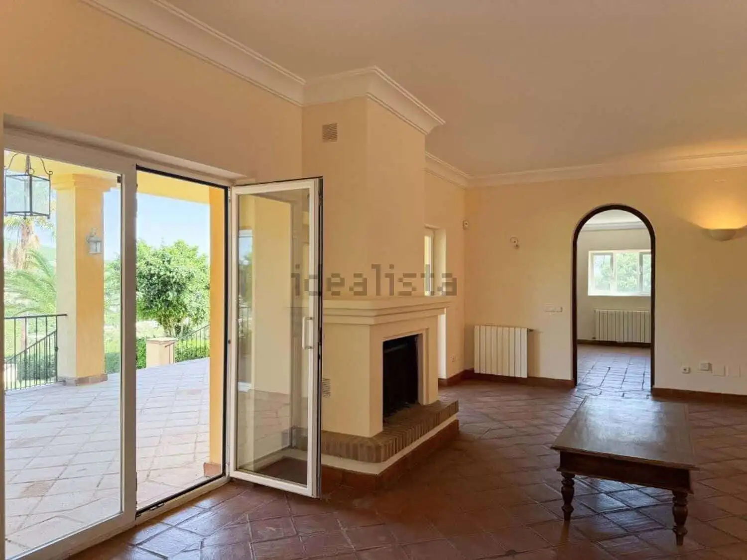 Beautiful living room with fireplace and access to outdoor terrace in Sotogrande.