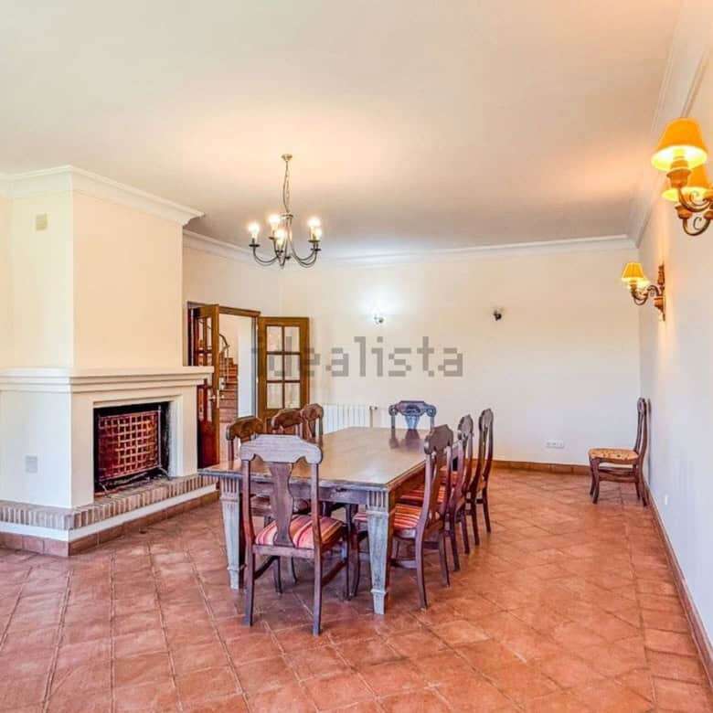 Spacious interior of a stunning 7-bedroom villa in Calle Fondo, Sotogrande, featuring a cozy firepla.