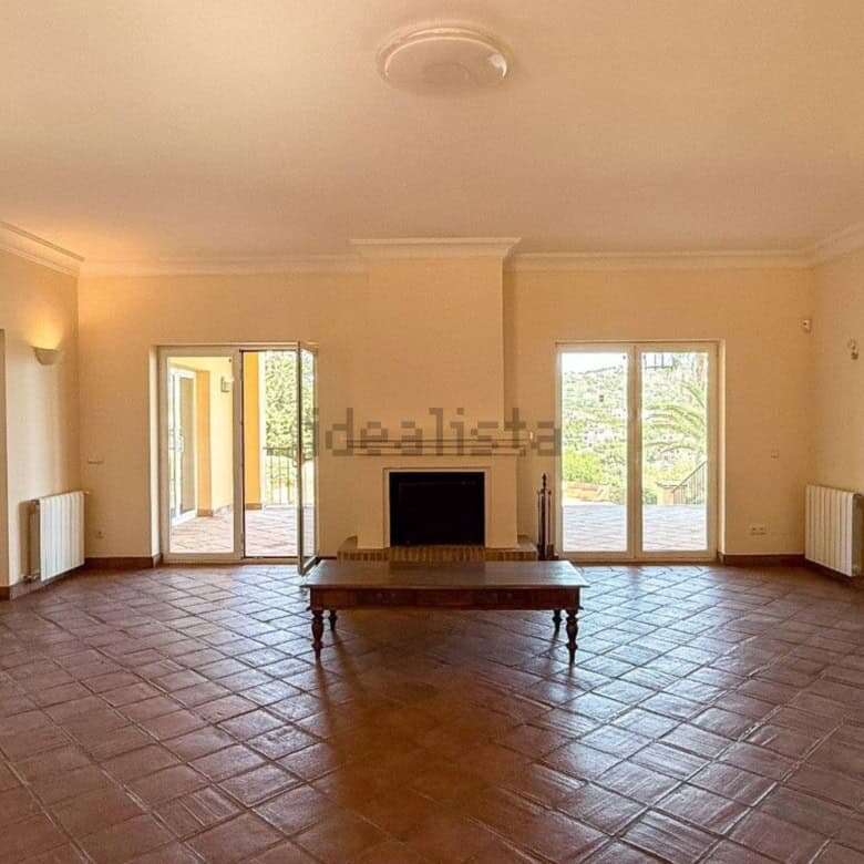 Bright living room with large windows and terrace doors in a stunning villa in Sotogrande.