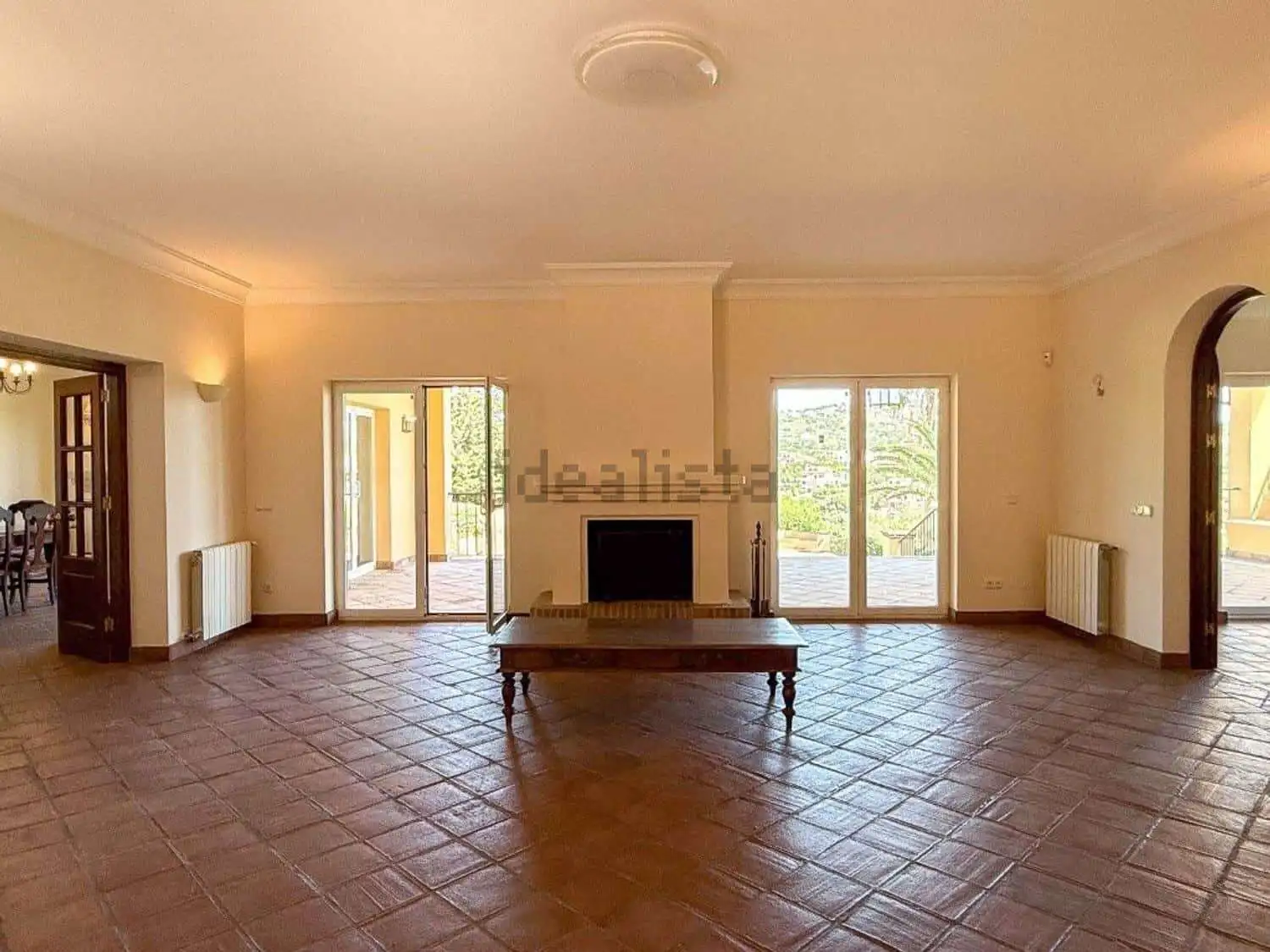 Bright living room with large windows and terrace doors in a stunning villa in Sotogrande.