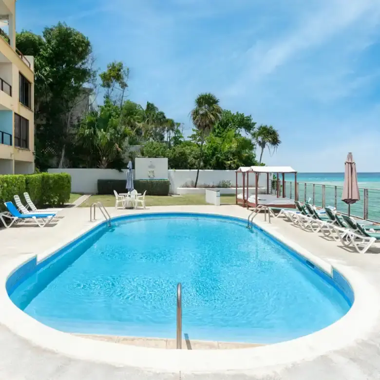 Beautiful poolside view of a luxury 2-bedroom apartment near St. Lawrence Beach, Christ Church.