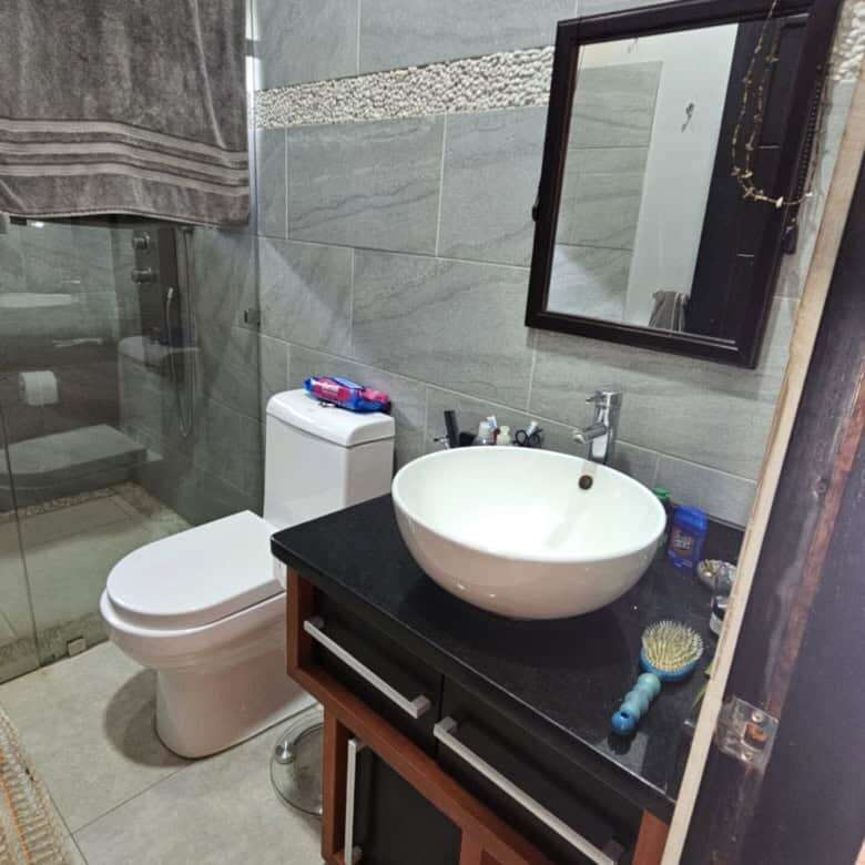 Modern bathroom with sink, mirror, and toilet in Costa Rica villa.