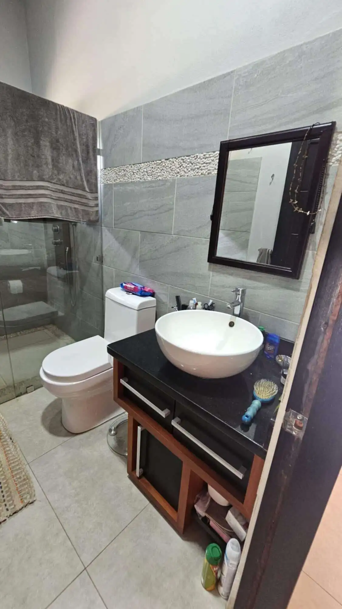 Modern bathroom with sink, mirror, and toilet in Costa Rica villa.