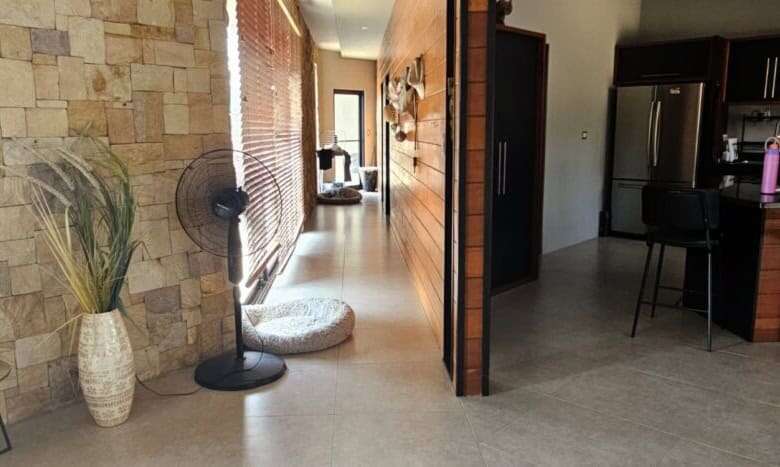 Spacious villa interior featuring contemporary decor, natural stone accents, and an open-plan living.