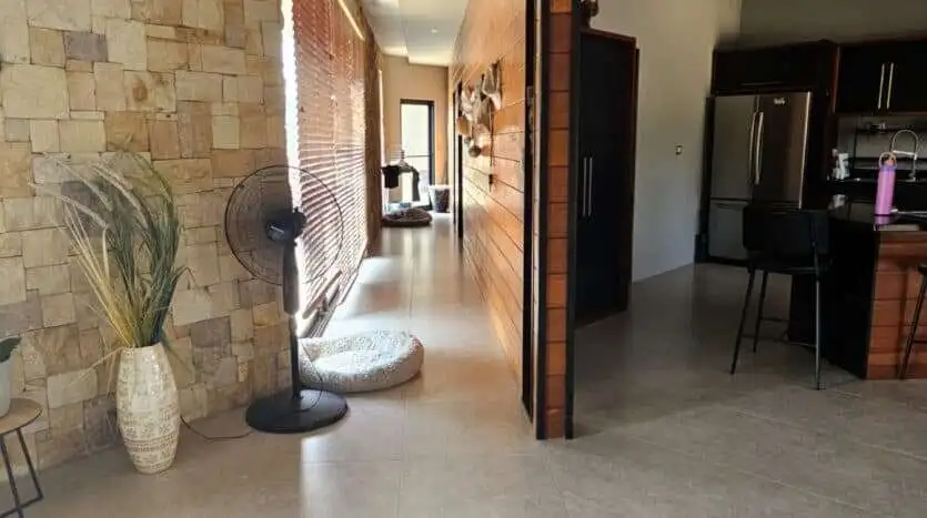 Spacious villa interior featuring contemporary decor, natural stone accents, and an open-plan living.
