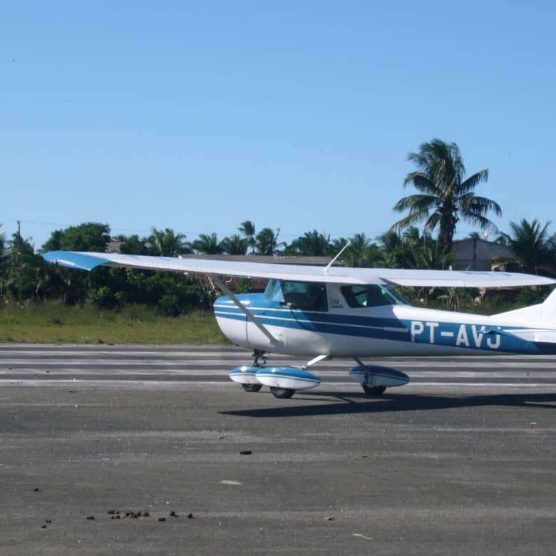 Small private aircraft parked on the runway in Bahia, Brazil.