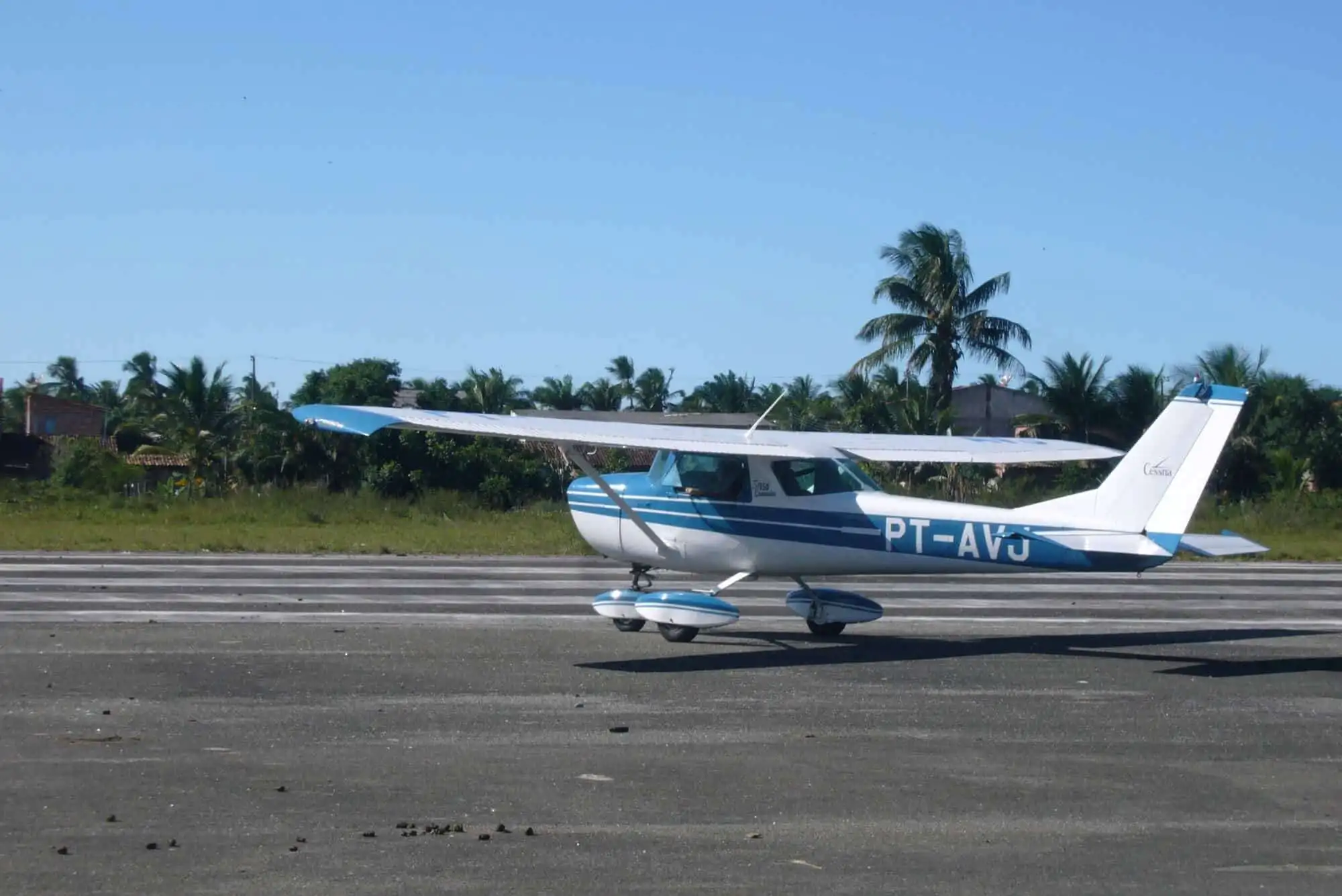 Small private aircraft parked on the runway in Bahia, Brazil.