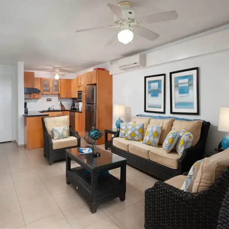 Spacious living room with stylish furniture and ocean-inspired decor in a luxury apartment near St.