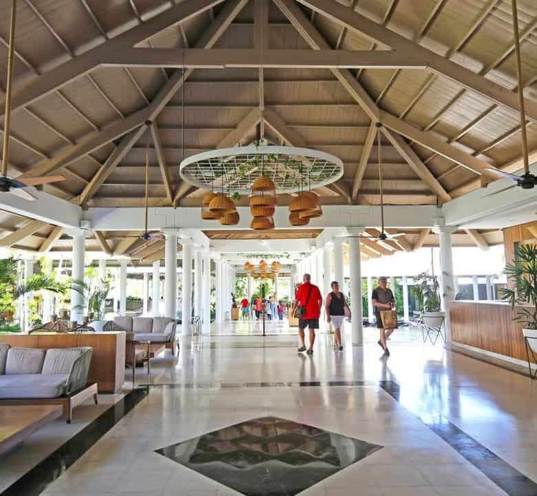 Modern resort lobby in Punta Cana with seating and tropical decor.