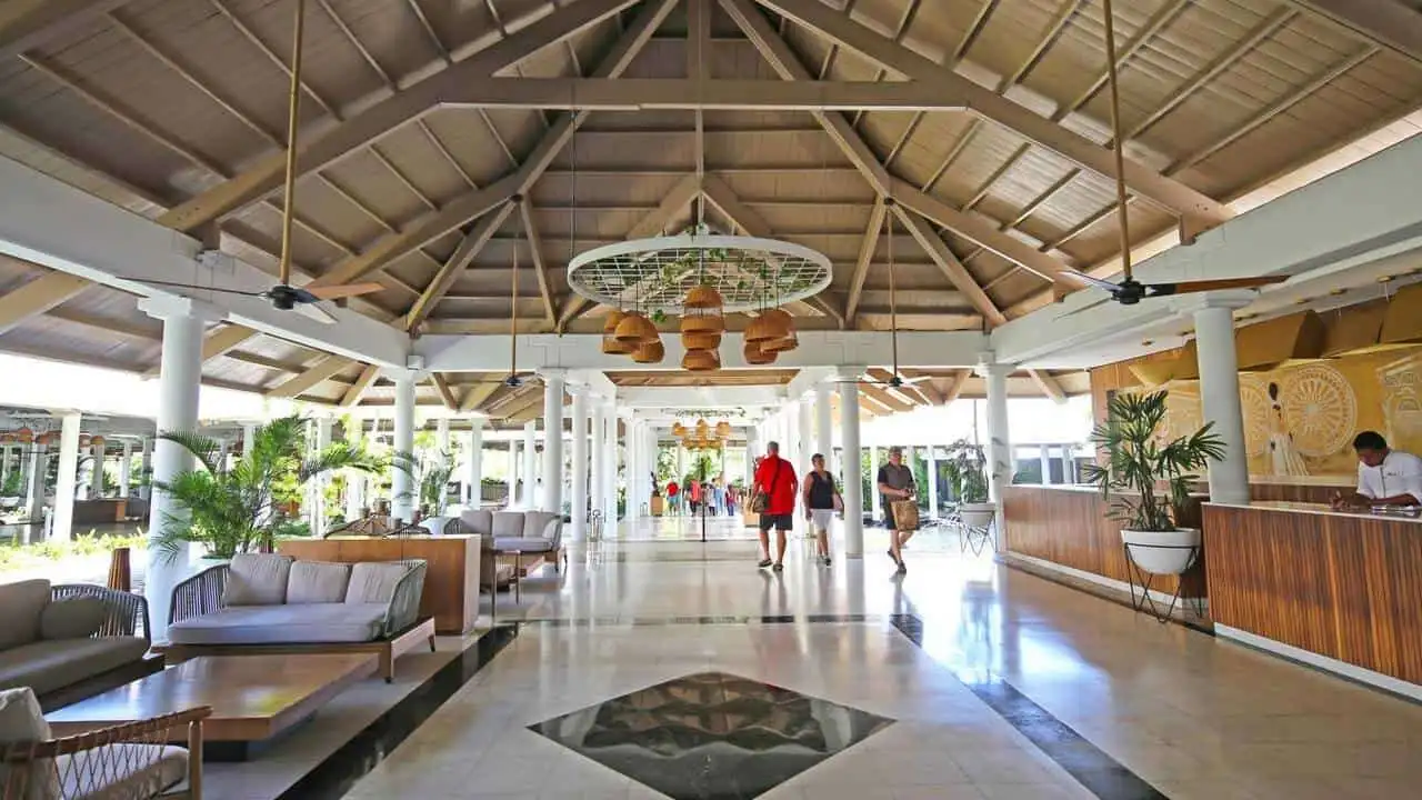 Modern resort lobby in Punta Cana with seating and tropical decor.