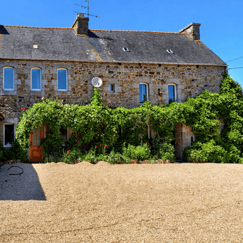 Stone Gite Complex in Brittany with lush garden and gravel courtyard.