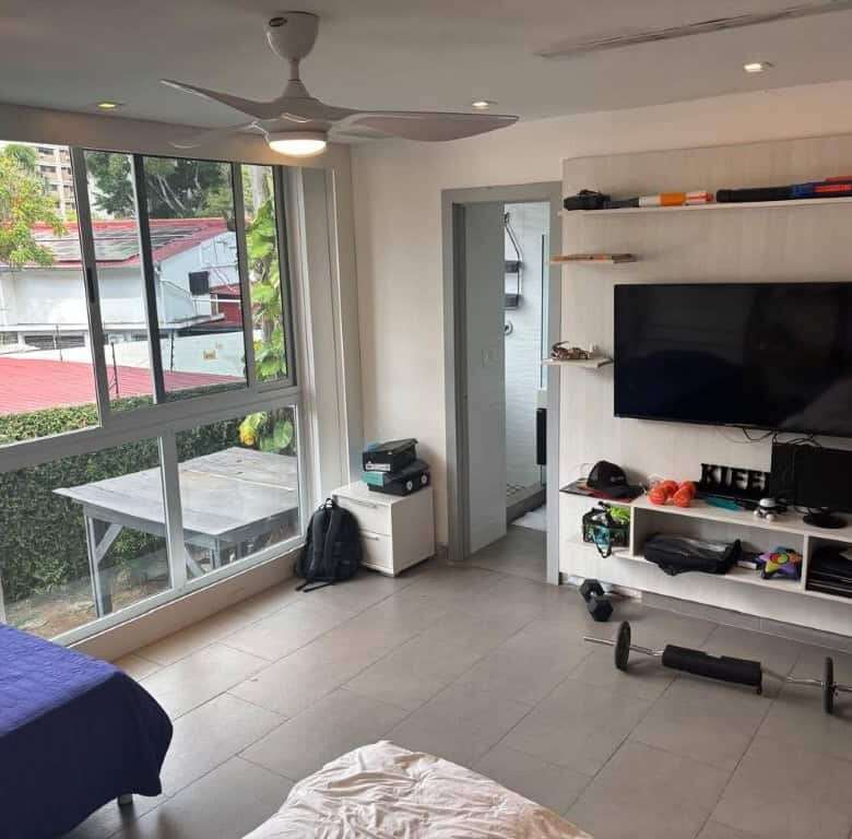 Spacious interior of a luxury apartment in Panama City with large windows and modern furnishings.
