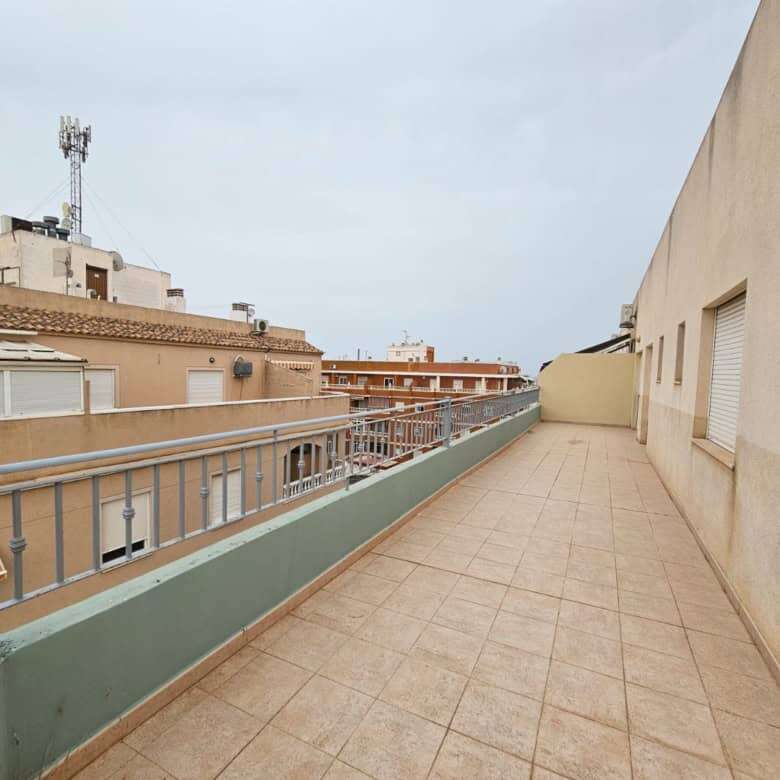 Large outdoor terrace of a penthouse apartment in Torrevieja with city views.