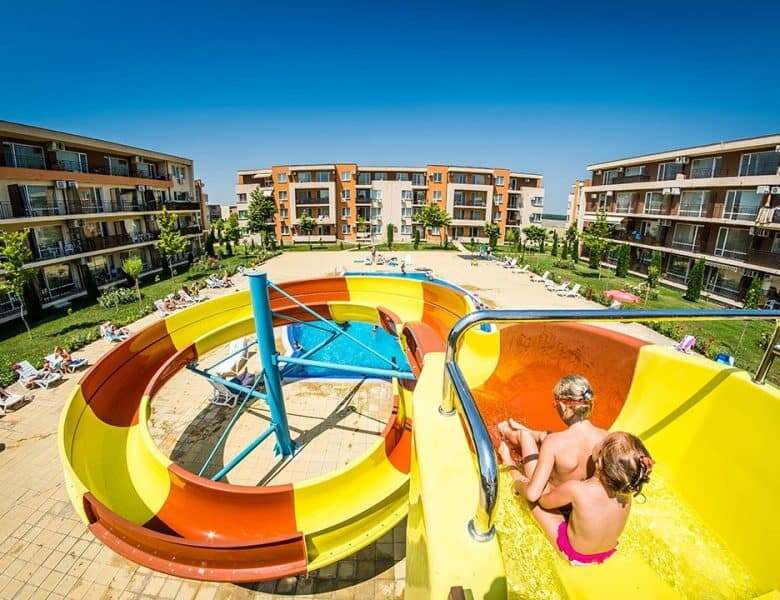 Pool area with water slides and sun loungers at Nessebar Fort Club, Sunny Beach.