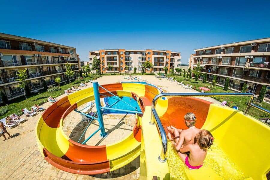 Modern pool area at Nessebar Fort Club, Sunny Beach, with water slides and sun loungers. Pool area with water slides and sun loungers at Nessebar Fort Club, Sunny Beach.