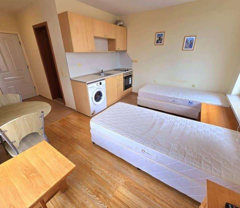 Bright studio with pool view, compact kitchen, and cozy sleeping area in Nessebar Fort club.