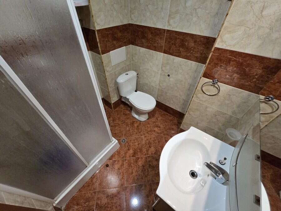 Modern bathroom with shower, toilet, and sink in Nessebar Fort club, Sunny Beach. Bathroom with shower, toilet, and sink in Nessebar Fort club, Sunny Beach.