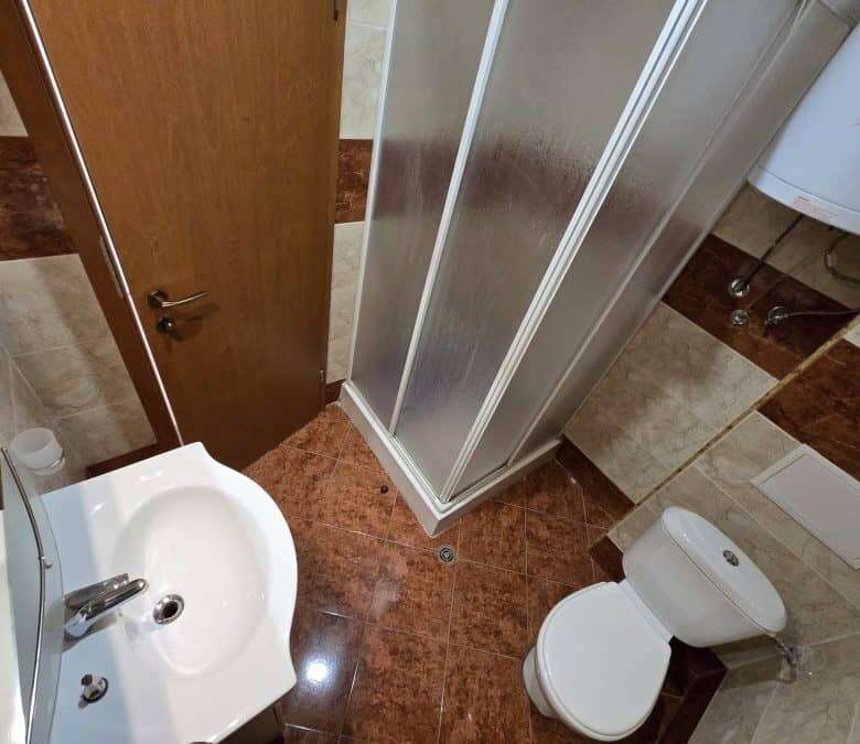Compact bathroom with shower, toilet, and sink in Nessebar Fort club.