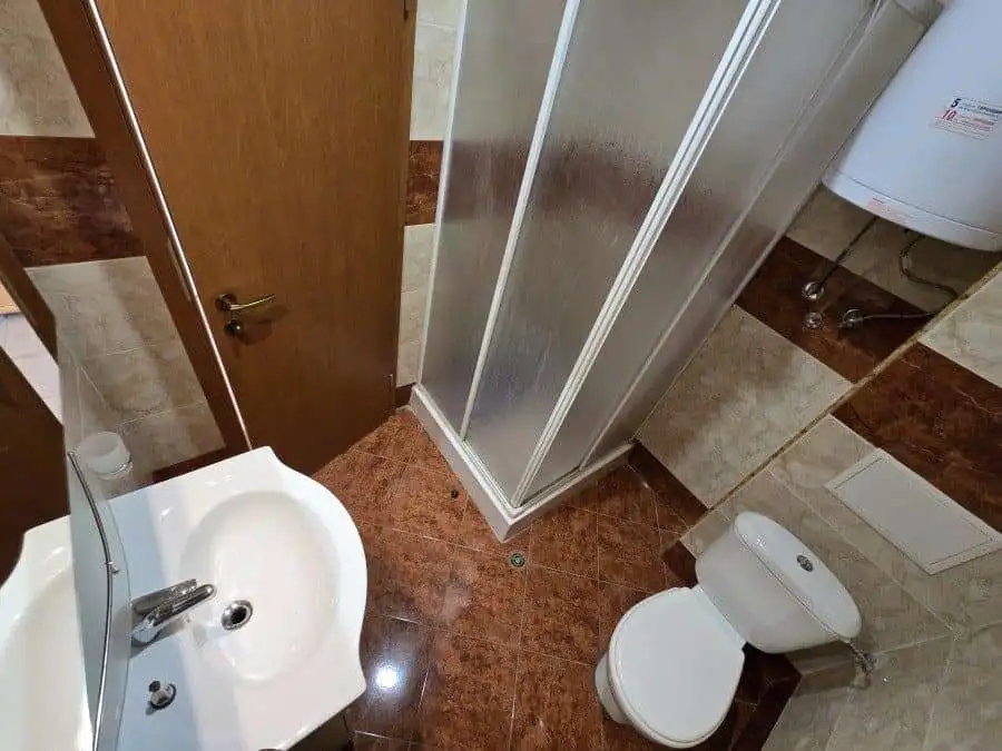 Compact bathroom with shower, toilet, and sink in Nessebar Fort club.