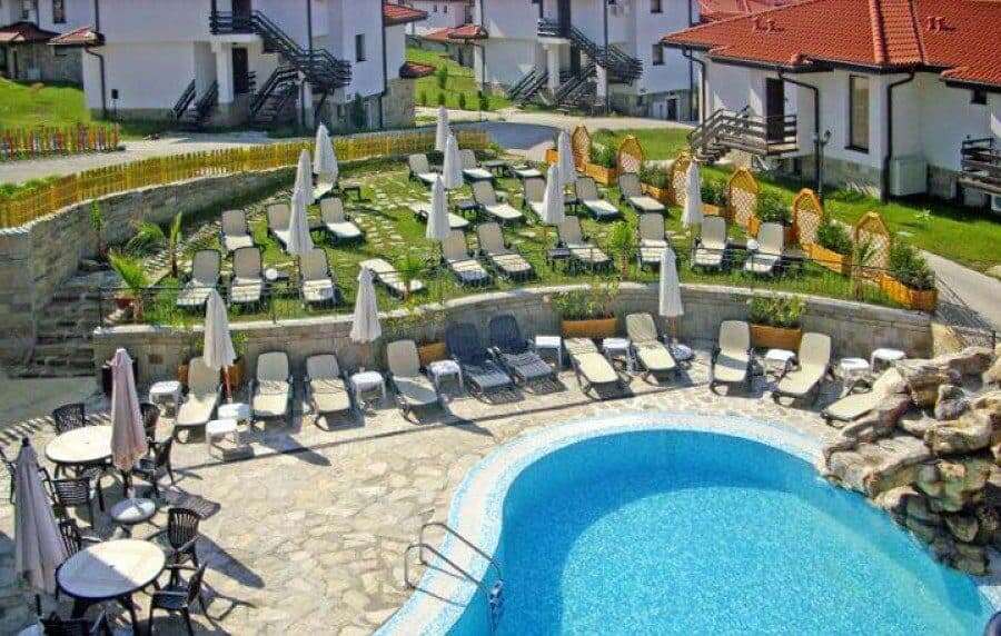 Pool area with sun loungers and umbrellas at Bay View Villas, Kosharitsa, Bulgaria.